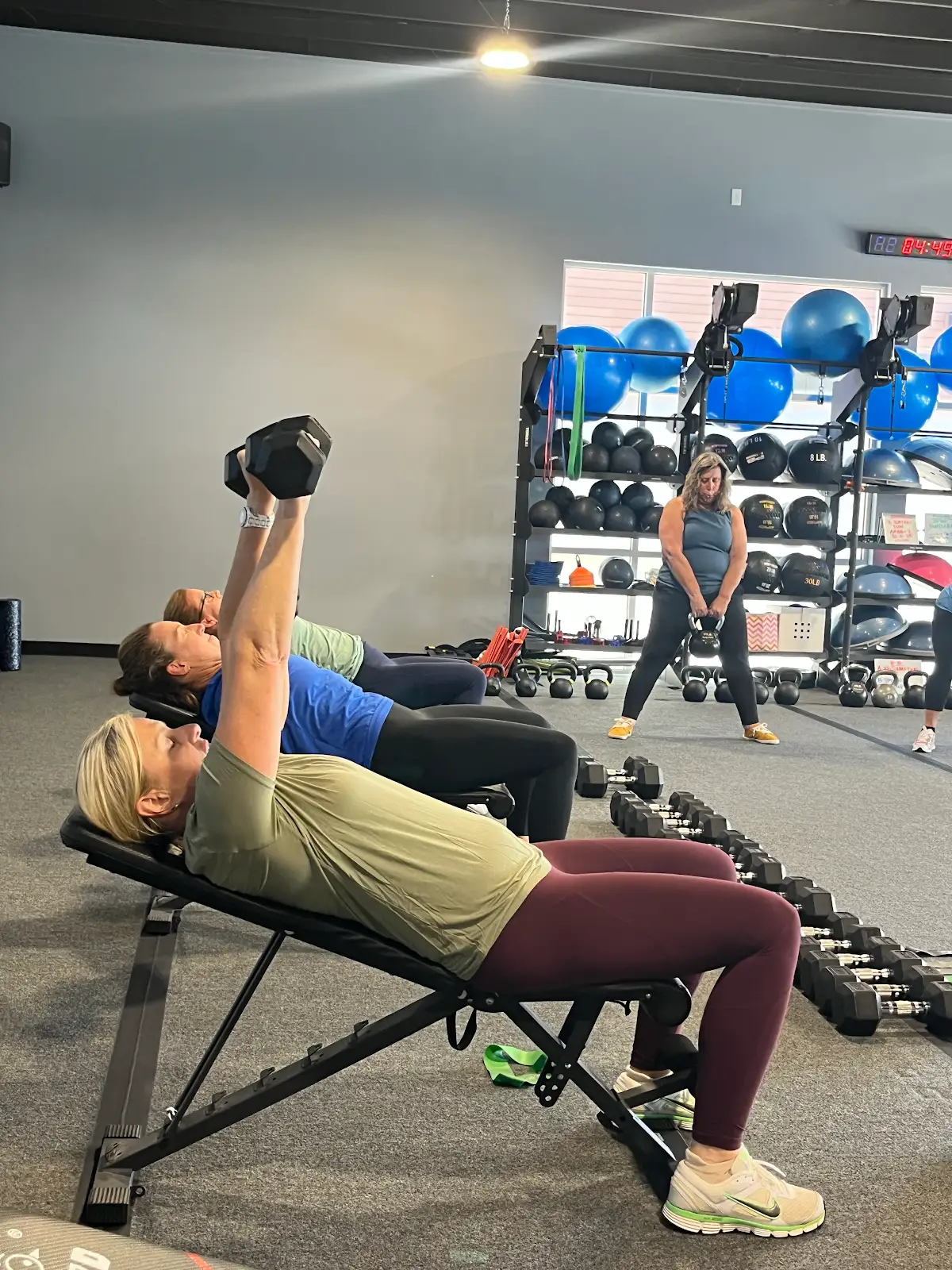 Members doing a dumbbell chest press